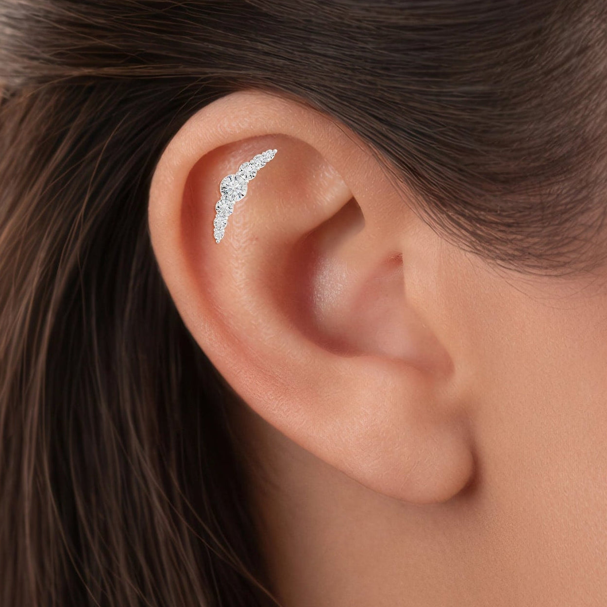 Close-up view of an ear model wearing long flat diamond piercing