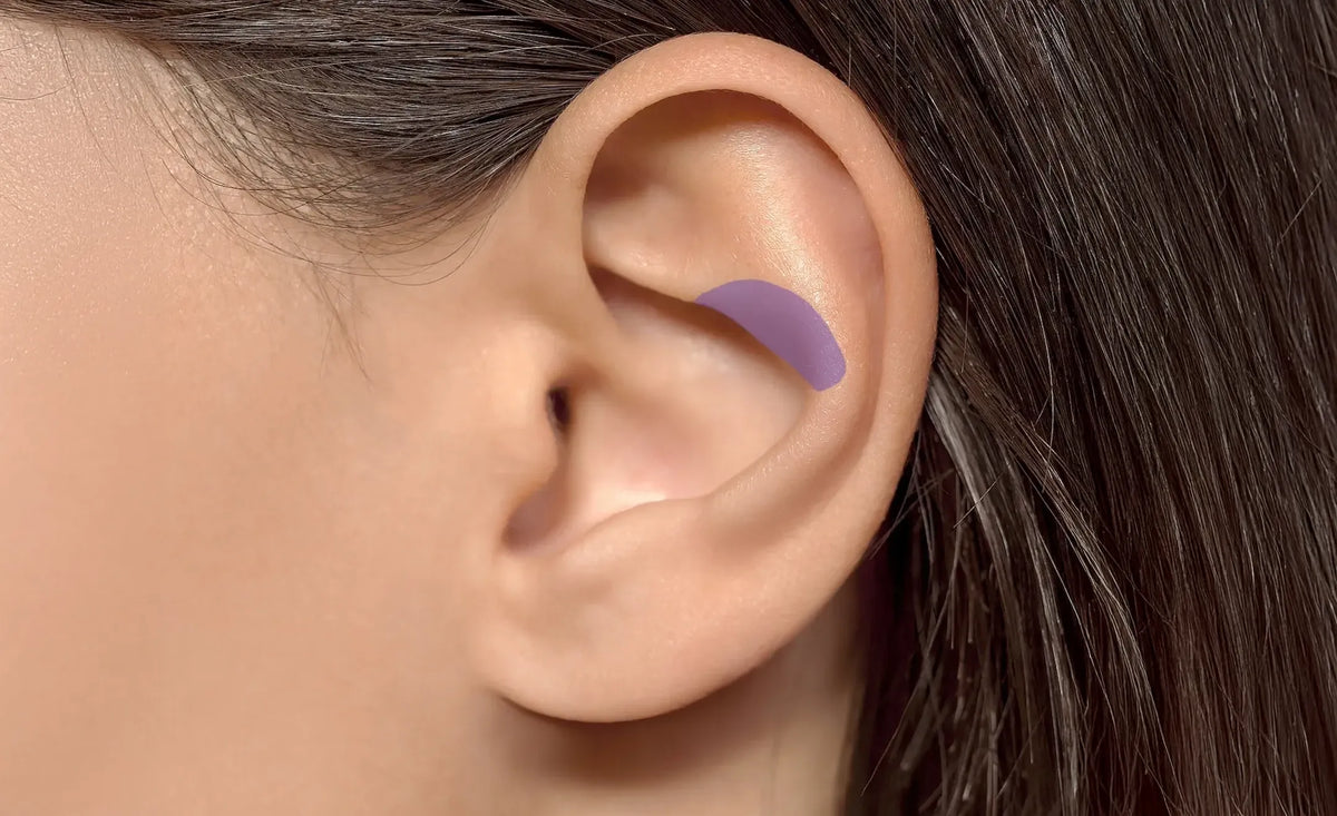 Close-up of a human ear with a purple curved highlighting the contraconch part of the ear
