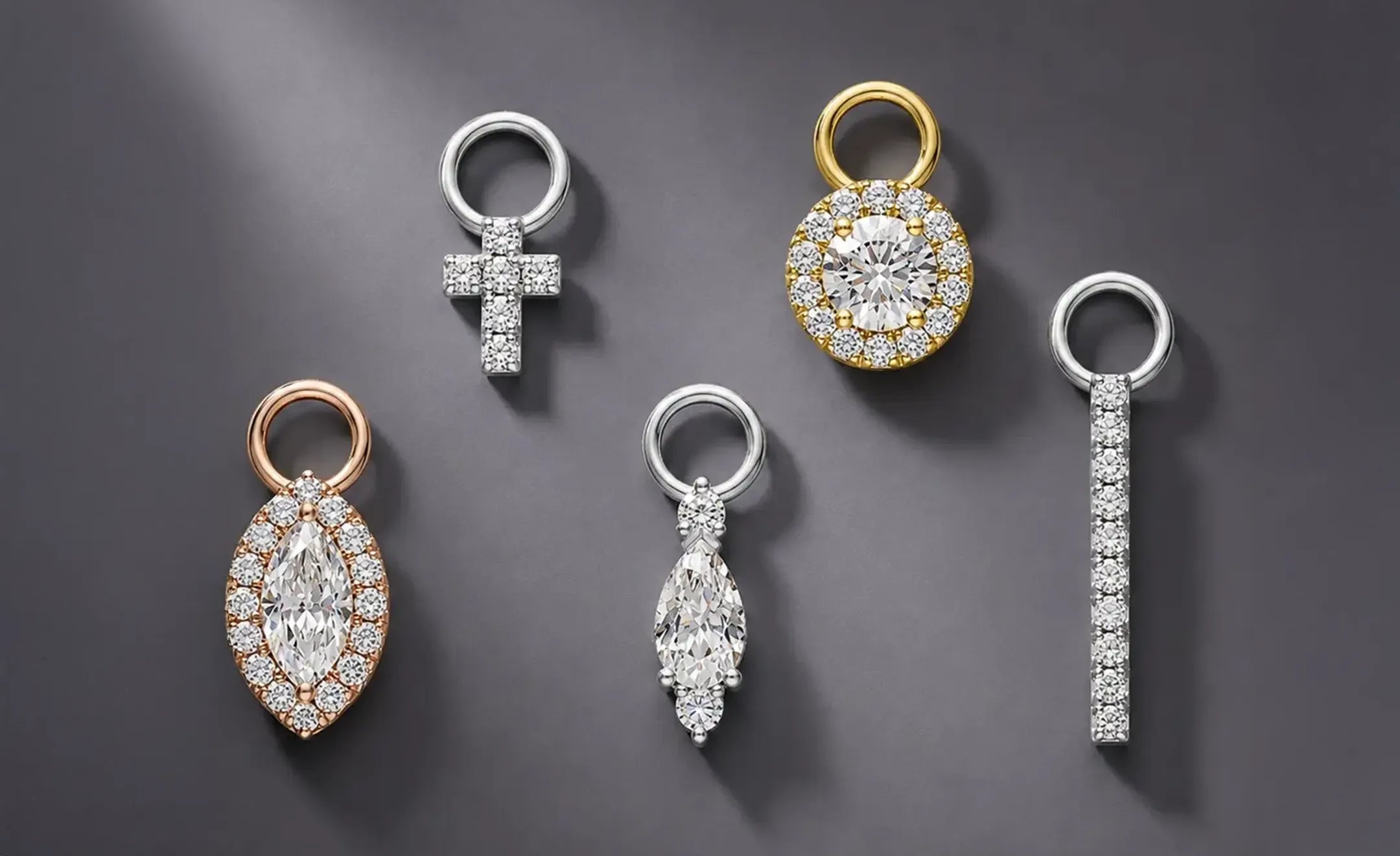 Five diamond jewelry charm in marquise halo, cross, round halo, bar and pear with round diamonds and metal finishes, including rose gold, yellow gold 
