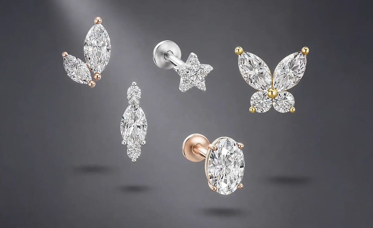 Five diamond stud earrings in various shapes including marquise, star, butterfly, oval, and pear with rounds crafted in 18k white, yellow, and rose gold against a dark gray gradient background.