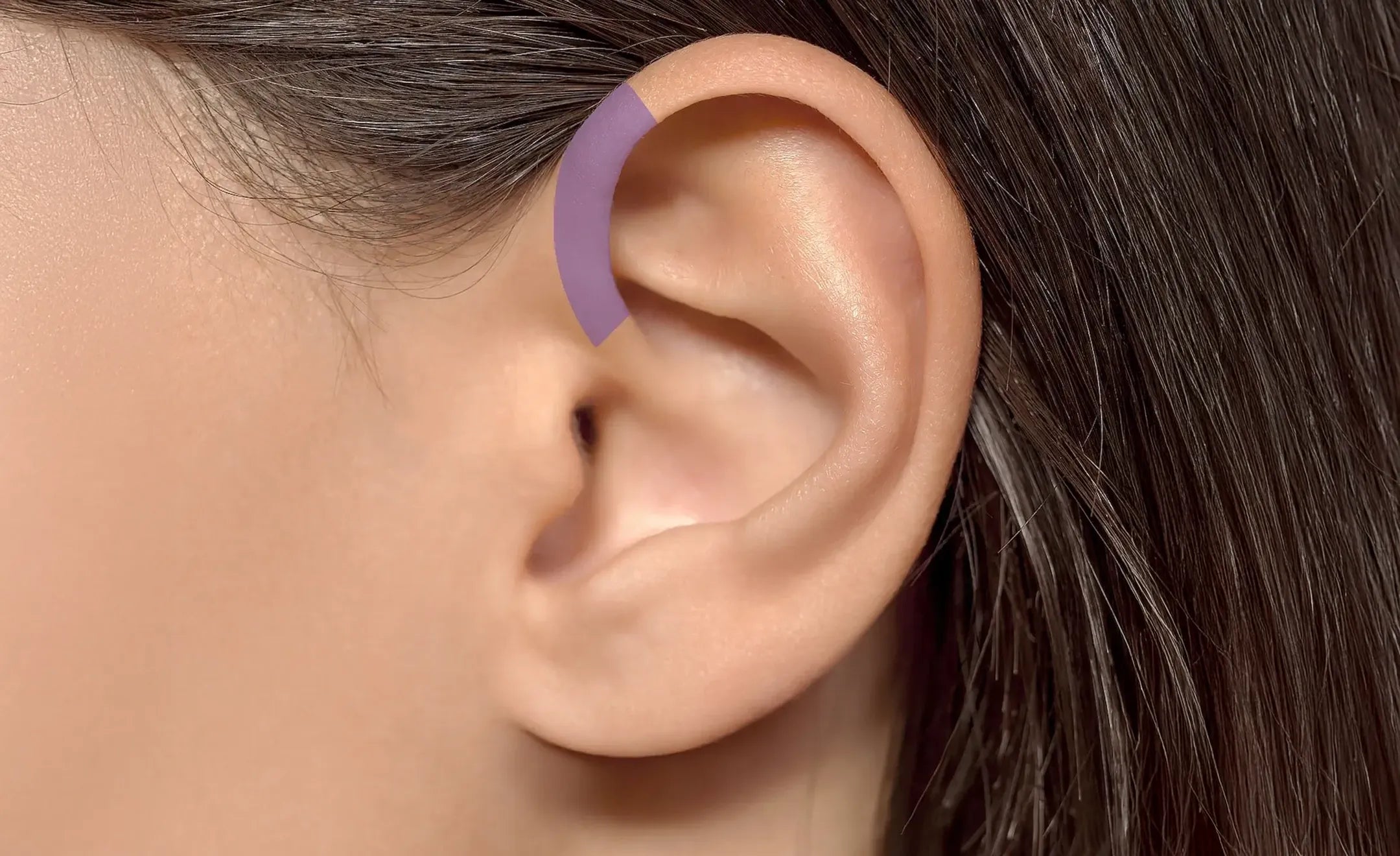 Close-up of a human ear with a purple curved highlighting the forward helix part of the ear