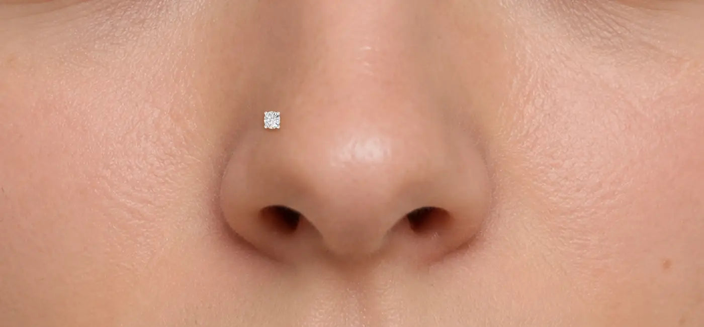 Close-up of a person's nose piercing