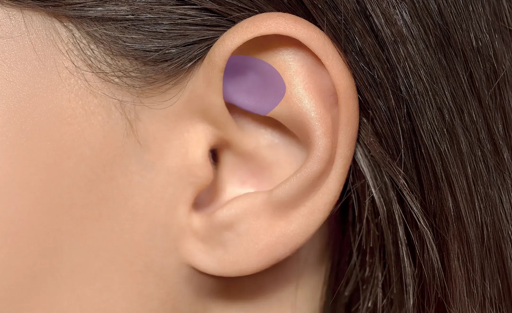 A close-up of a person's ear with a purple highlight on the rook part of the ear 