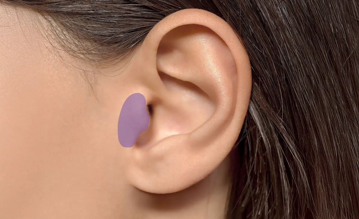 Close-up of a human ear with a purple highlight on the tragus part of the ear